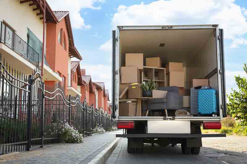 moving truck on street in front of row houses or condos