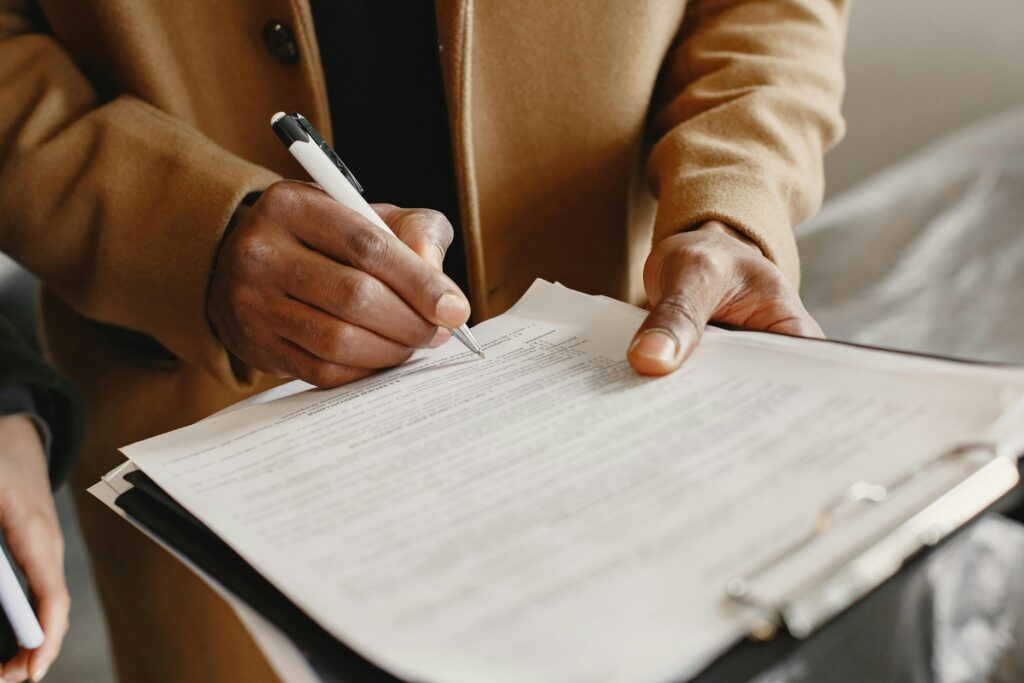 Man in suit signing a written agreement.