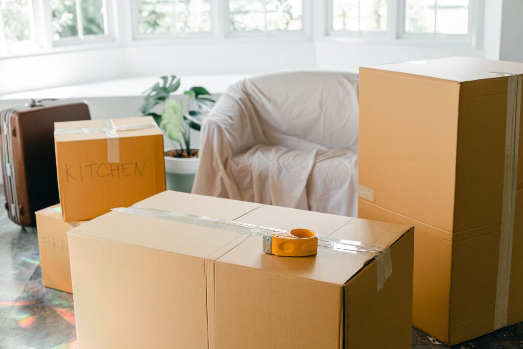 Packed and taped moving boxes ready to be loaded onto the truck.
